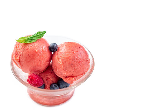 Bowl of pink strawberry ice cream frresh berry znd mint isolated on white