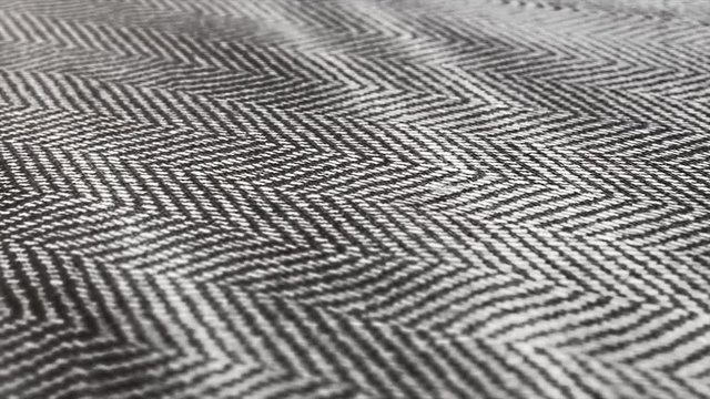 Herringbone background, macro shot of tweed fabric cloth waving. 