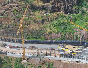 aerial view of a new road under construction with crane and construction materials and machinery...