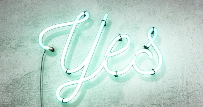 Blue/green neon sign saying the word Yes on a grey concrete wall background, the footage starts with the sign off, then it stays on for 30 seconds them flashes on and off for another 30 seconds.