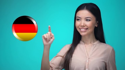 Curious woman pushing German flag button, ready to learn foreign language - Powered by Adobe