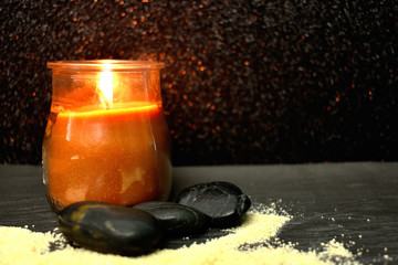 Flaming Candle whit stones, symbolizing calm, harmony and meditation.