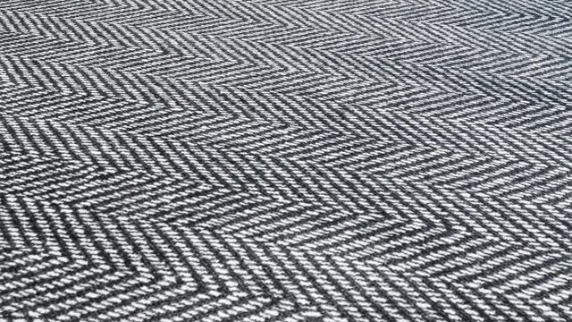Herringbone background, macro shot of tweed fabric cloth. 