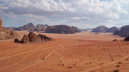 Fototapeta na wymiar Panoramic view to the landscape of the Wadi Rum desert with red sand dunes and rocks in Jordan. 