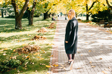 beautiful stranger in black coat walks away