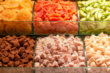 Dried fruits and turkish delight on the counter. In different colors and nuts, such as walnuts, nuts.