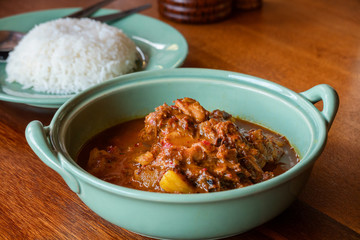 Beef massaman curry with rice on wooden table, Thai food