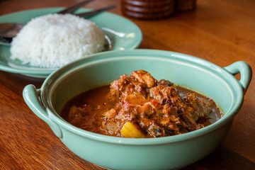 Beef massaman curry with rice on wooden table, Thai food