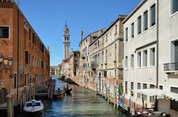 Fototapeta na wymiar Docked boats on a canal in Venice