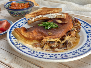 Omelet with fried onions and mushrooms.Baked beans and fresh tomatoes.On a wooden tray.