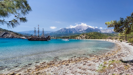 Fototapeta na wymiar View of Tahtali Mountain and a bay with a boats, Phaselis, Kemer, Antalya