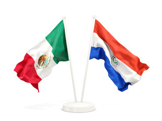 Two waving flags of Mexico and paraguay isolated on white