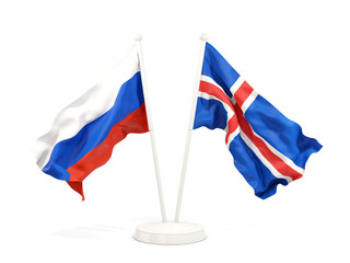 Two waving flags of Russia and iceland isolated on white