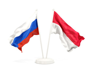 Two waving flags of Russia and indonesia isolated on white