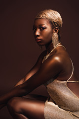 fashionable african american woman with short hair isolated on brown