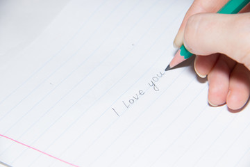 Text in pencil on paper I love you. Declaration of love on paper. Text on paper. I love you.