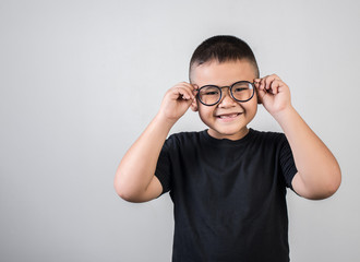 Funny boy genius wearing glasses in studio shot