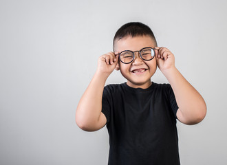 Funny boy genius wearing glasses in studio shot