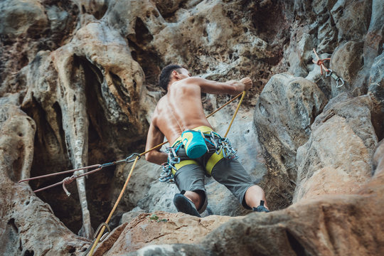Mountain climber on Climbing Route on Tonsay beach in Krabi, Thailand.