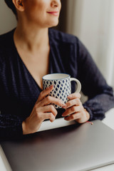 Drinking her morning coffee