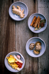 Ingredients for Chinese herbal soup on shabby wooden background .