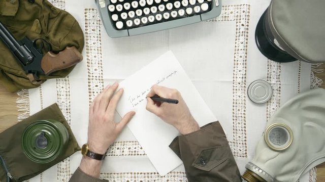 A soldier writing a letter. 50's 60's 70's vintage scene. Historical reenactment concept.