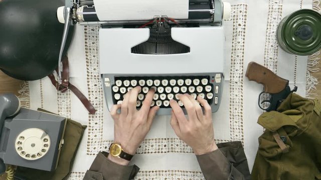 A soldier typing a letter on a typewriter. 50's 60's 70's vintage scene. Historical reenactment concept.