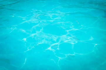 Fototapeta na wymiar Swimming pool blue water reflecting the sun rippled details. 