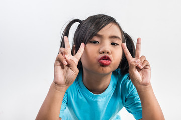 Portrait of Funny little girl acting in studio shot