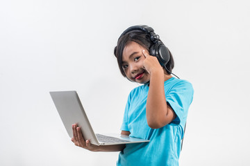 Little girl using laptop computer and listening lesson online