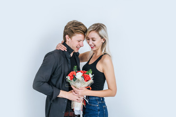 Portrait of happy young couple love together with flower in studio