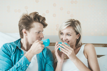 Obraz na płótnie Canvas Happy couple hand holding cup and drinking coffee in the morning