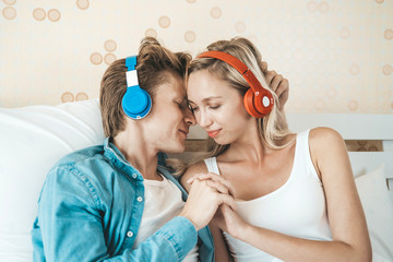 Happy couple listening song in the morning at bedroom