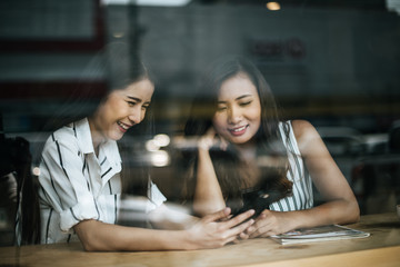 Two beautiful women talking everything together at coffee shop cafe