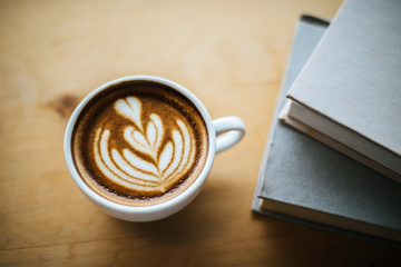 Latte art in coffee cup on the cafe table