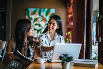 Two beautiful women talking everything together at coffee shop cafe