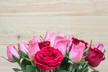 A bouquet of roses on a wooden background