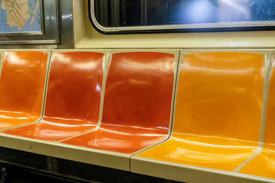 Colorful seats in a New York City subway car © elvis901
