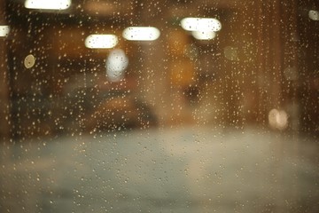 Glass with glare and drops after rain