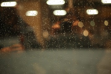 Glass with glare and drops after rain