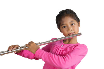 The isolated image of a girl wearing a pink long-sleeved shirt is playing flute. © nakhonthesis