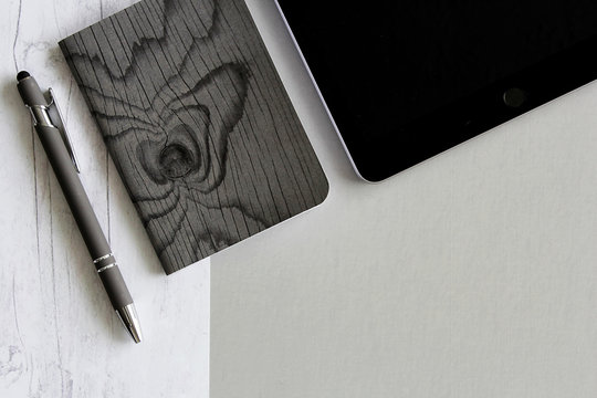 tablet notebook journal pen on split background