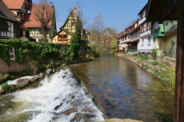 Fototapeta na wymiar Clear rushing stream running through an old Medieval village