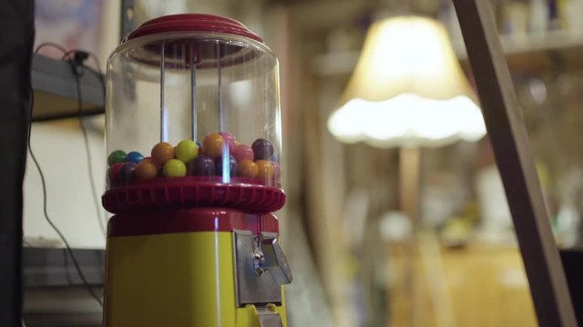 Old vintage gumball machine in a dimly lit garage