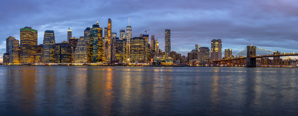 Naklejka na ściany i meble Panorama scene of New york Cityscape with Brooklyn Bridge beside the east river at the twilight time, USA downtown skyline, Architecture and building with tourist concept