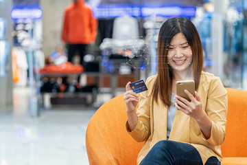 "Asian women using the technology tablet for access control by face recognition in private identification step when online shopping with the credit card, credit card mockup, online payment concept,."
