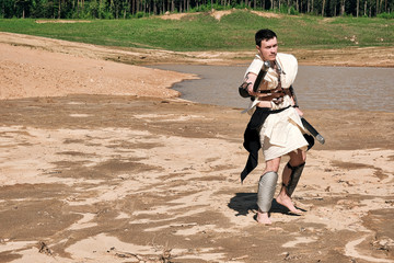 Concept photo of a Roman warrior of the Colosseum in action with aggressive emotions in full...