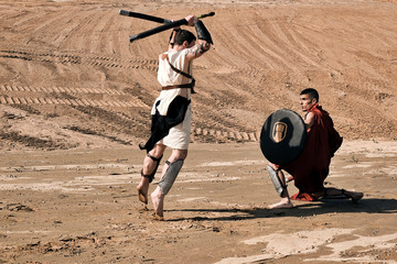 A concept photo of a Roman battle of two warriors of the Colosseum in action with aggressive...