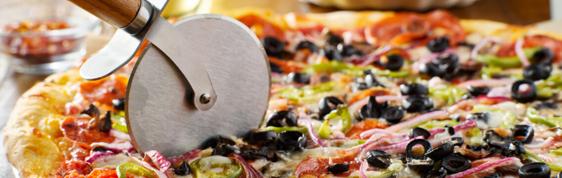 tasty supreme pizza with olives peppers onions and sausage panorama - Powered by Adobe