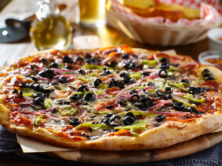 tasty supreme pizza with olives peppers onions and sausage